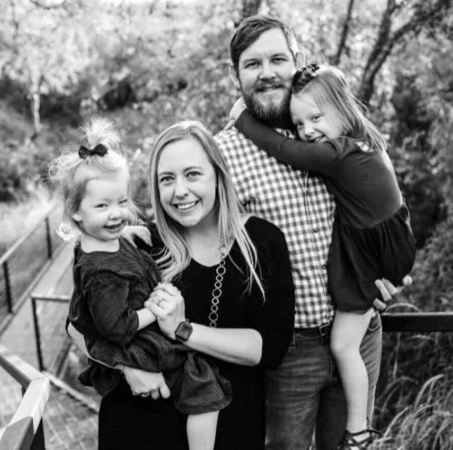 Family of four take Christmas photos together out in beautiful nature scenery