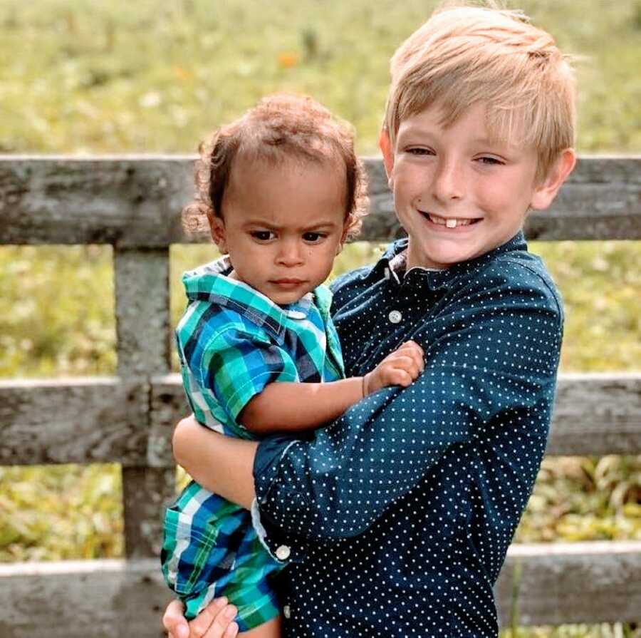 Mom snaps a photo of her two adopted sons spending quality time together during a family photoshoot