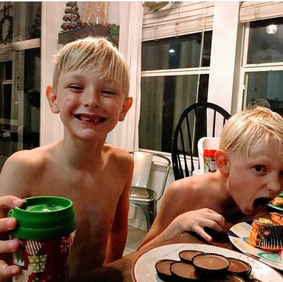 Mom snaps a photo of two of her sons, one adopted and one biological, eating sweets together to celebrate his adoption day