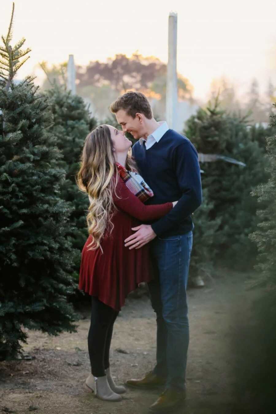 Husband and wife take Christmas-themed maternity photos together to celebrate their first daughter together
