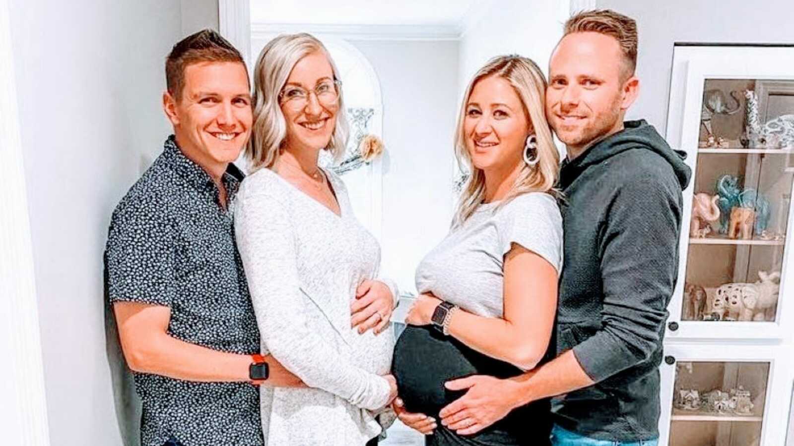Two sisters pregnant at the same time take pictures with their husbands while showing off their belly bumps
