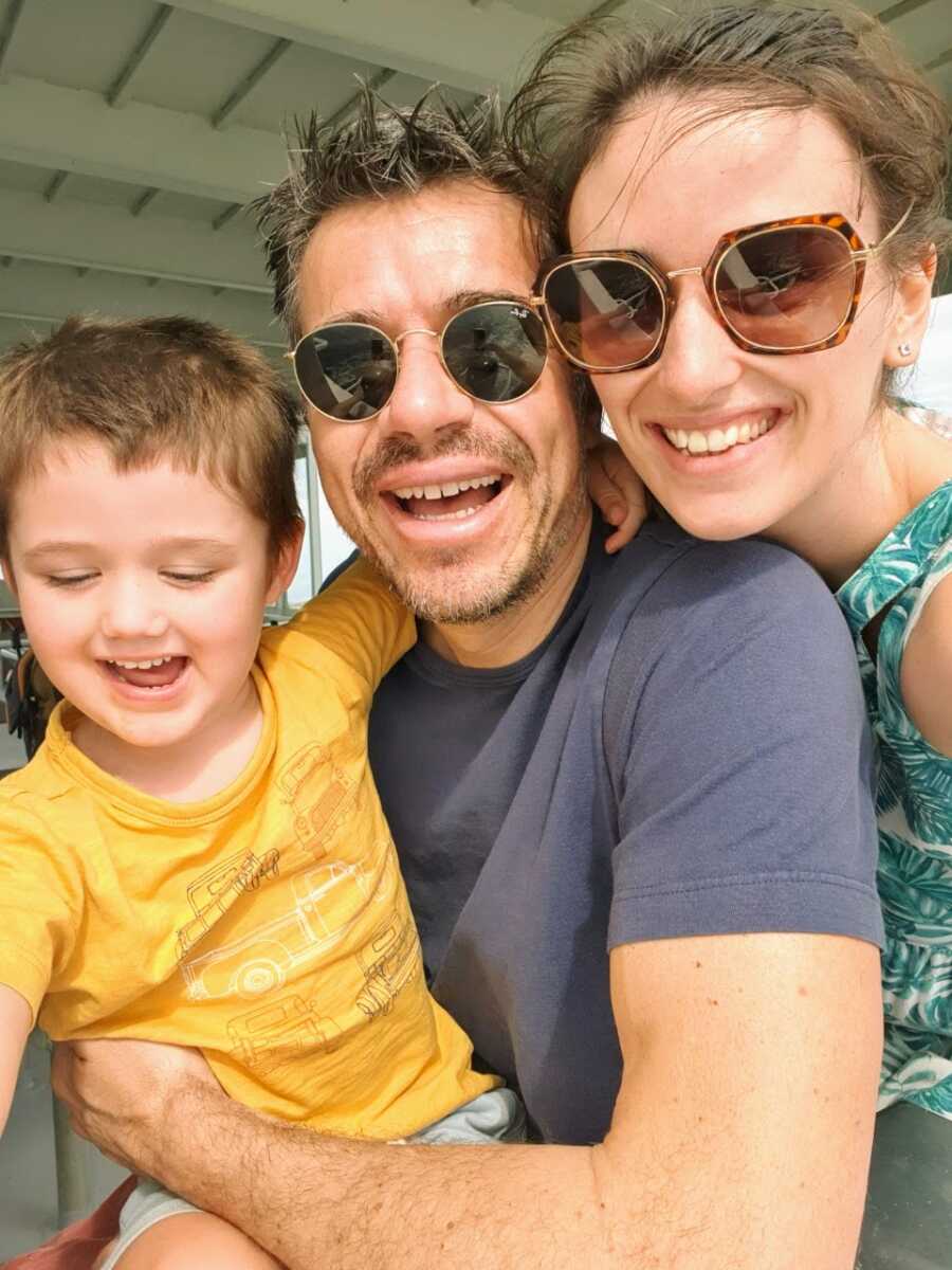Woman on healing journey from abusive relationship poses for a selfie with her new boyfriend and her son