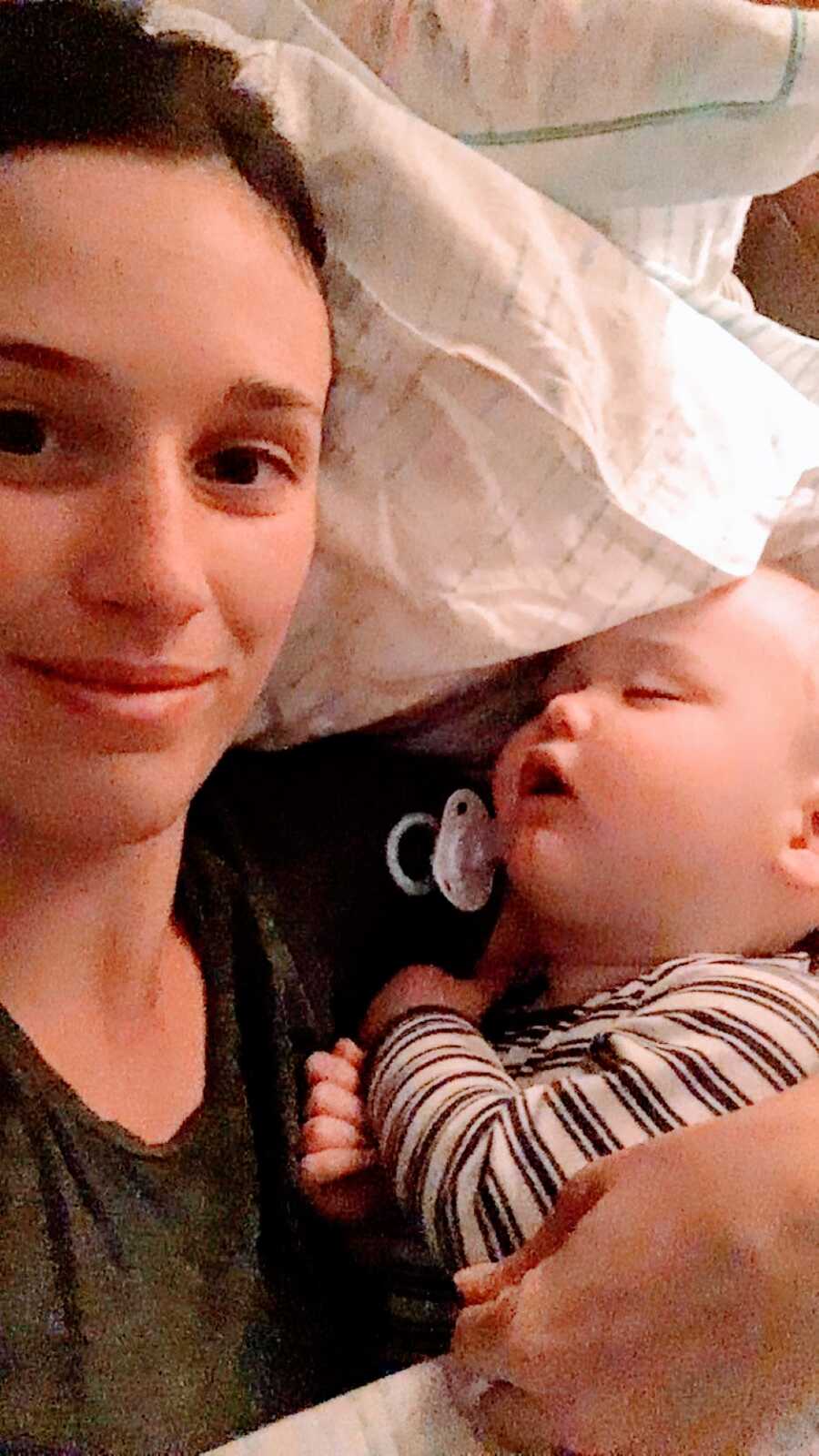 Woman dating a narcissistic sociopath cuddles with her young son in bed