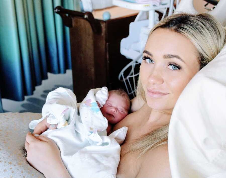First time mom holds her newborn son in the hospital after giving birth to him