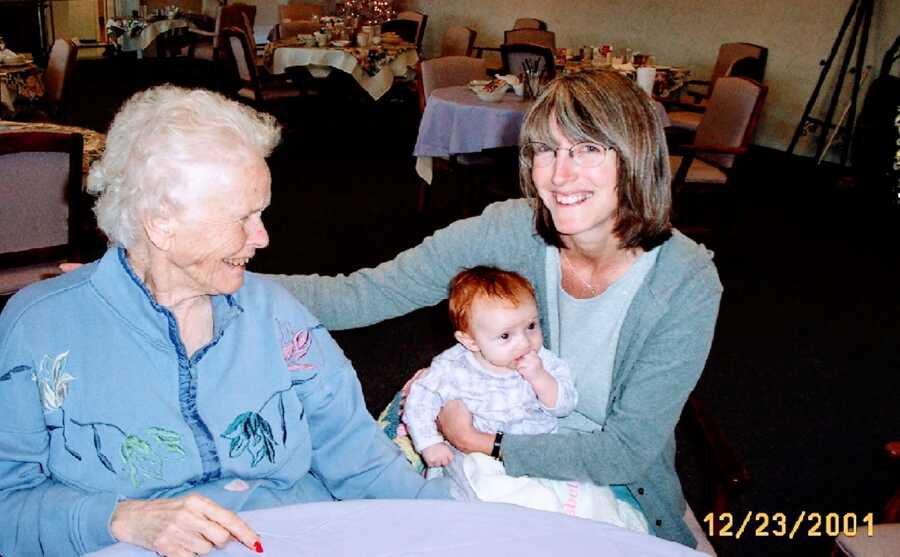 woman holds daughter next to mom with Alzheimer's