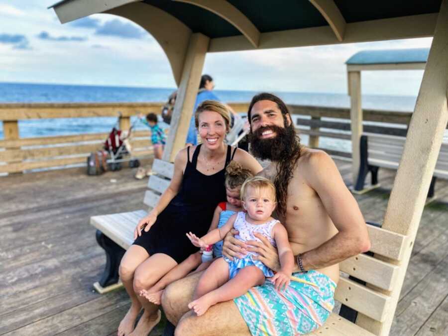 mom and dad with two children on bench