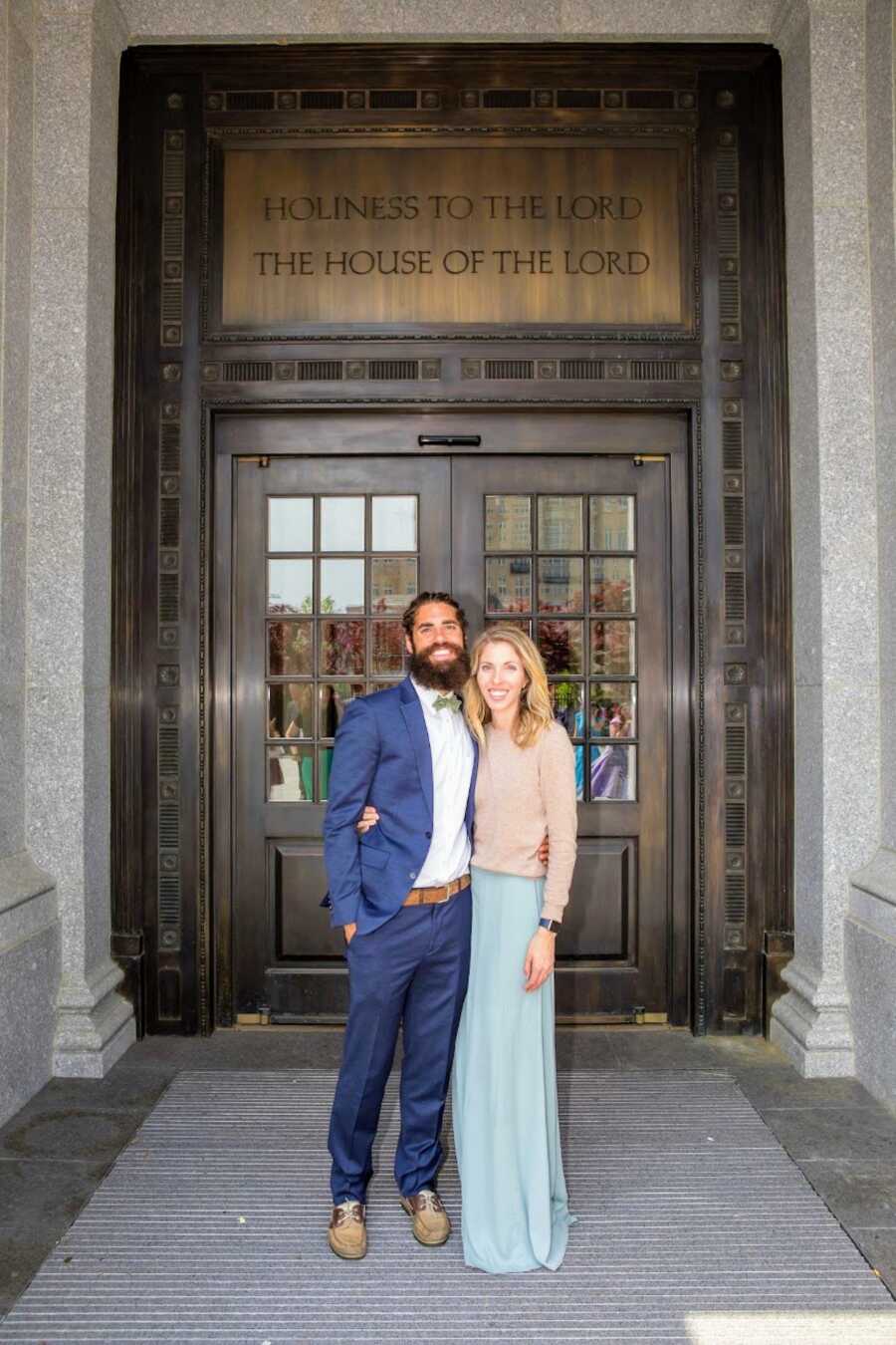 woman and man dressed up in front of door