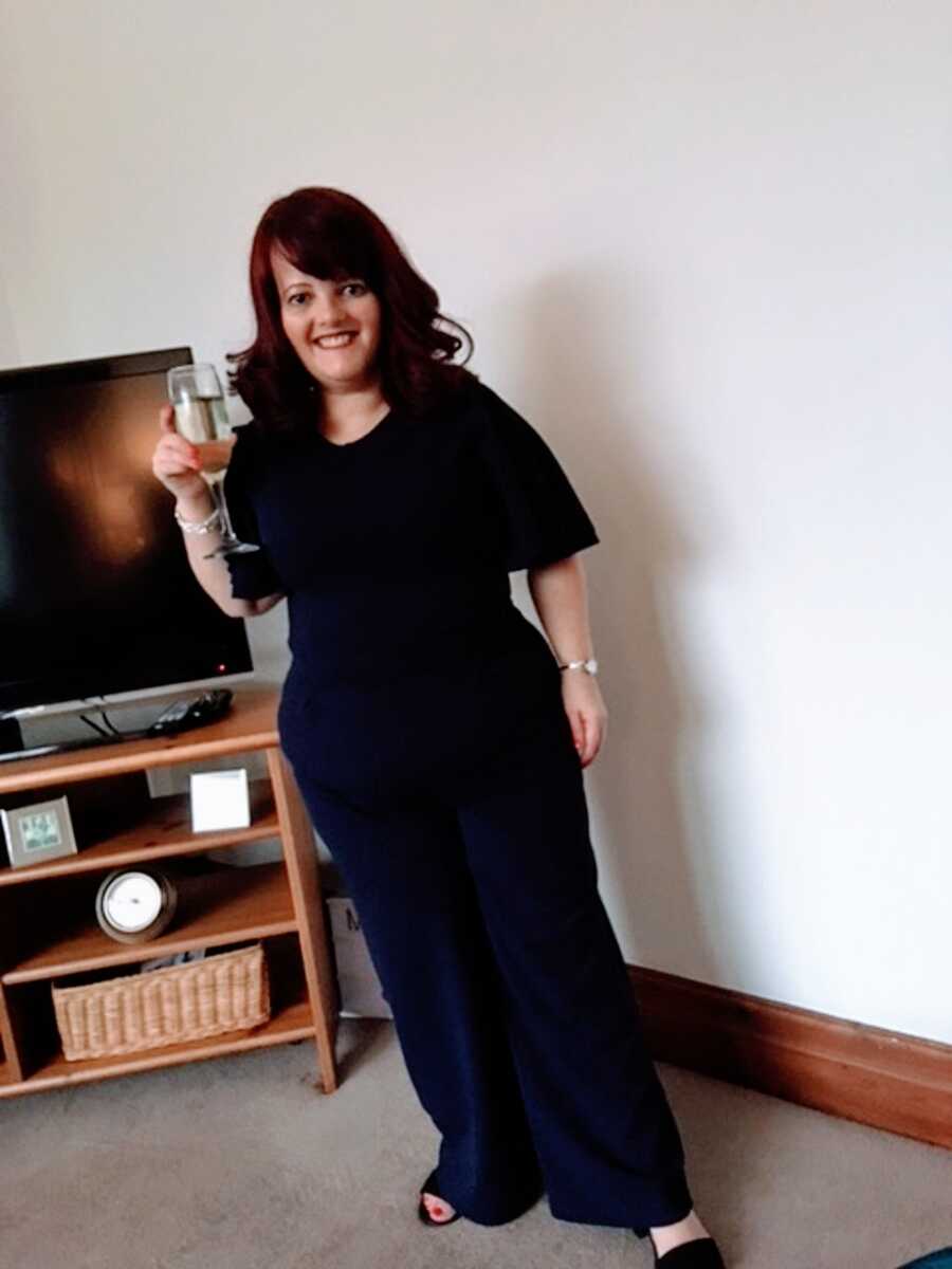 A woman with RSS stands in her living room