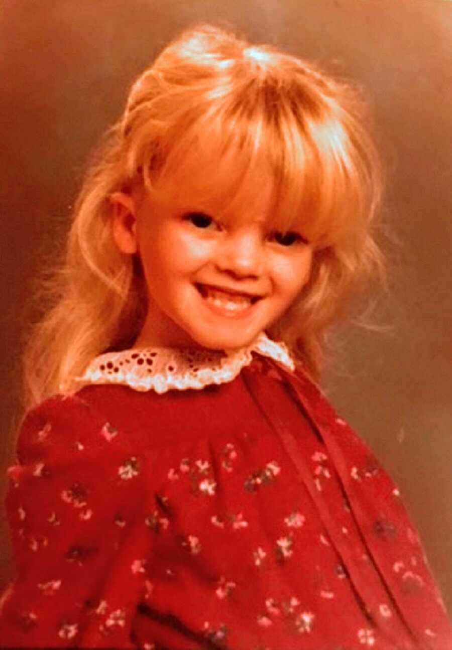 A girl with a rare growth disorder wearing a red dress