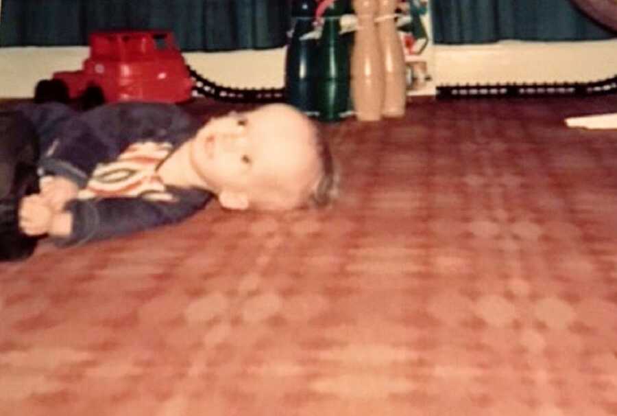 A child with RSS lying on the floor