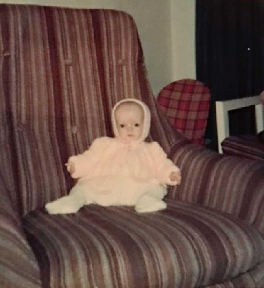 A baby girl with Russell-Silver Syndrome sitting in a chair