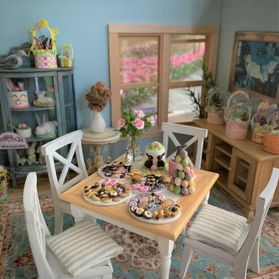 Miniature Easter dollhouse scene featuring clay sculpted cookies and cakes.