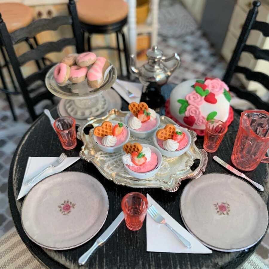 Miniature pink desserts made from sculpted clay.