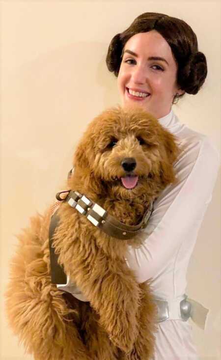 Woman and her dog's Princess Leia and Chewbacca costumes. 