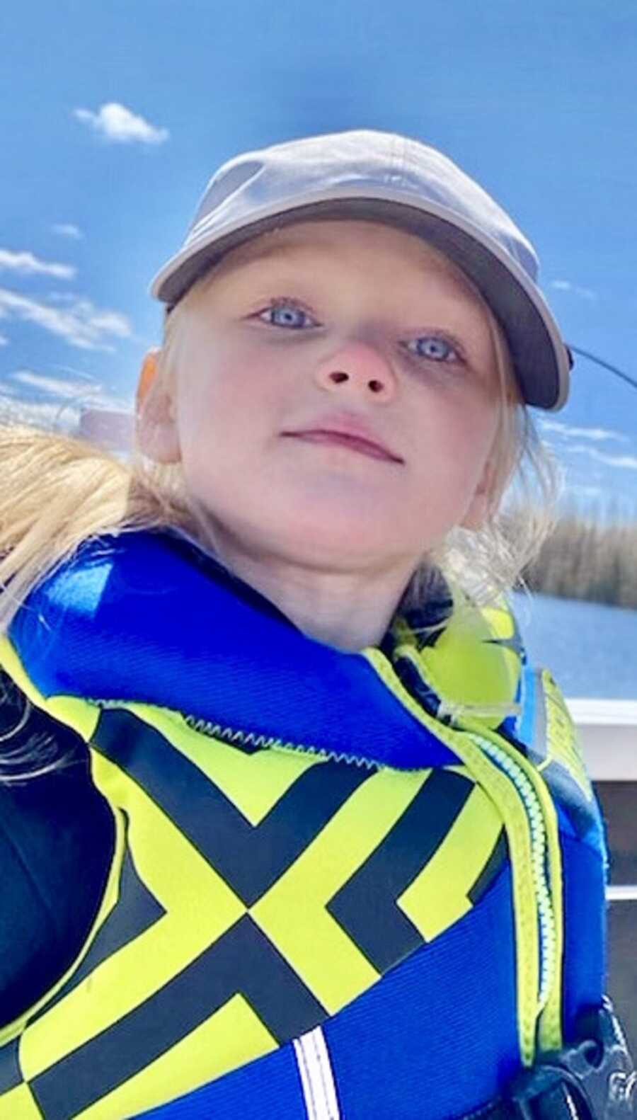 Evie wears a life vest while enjoying being out on the water. 