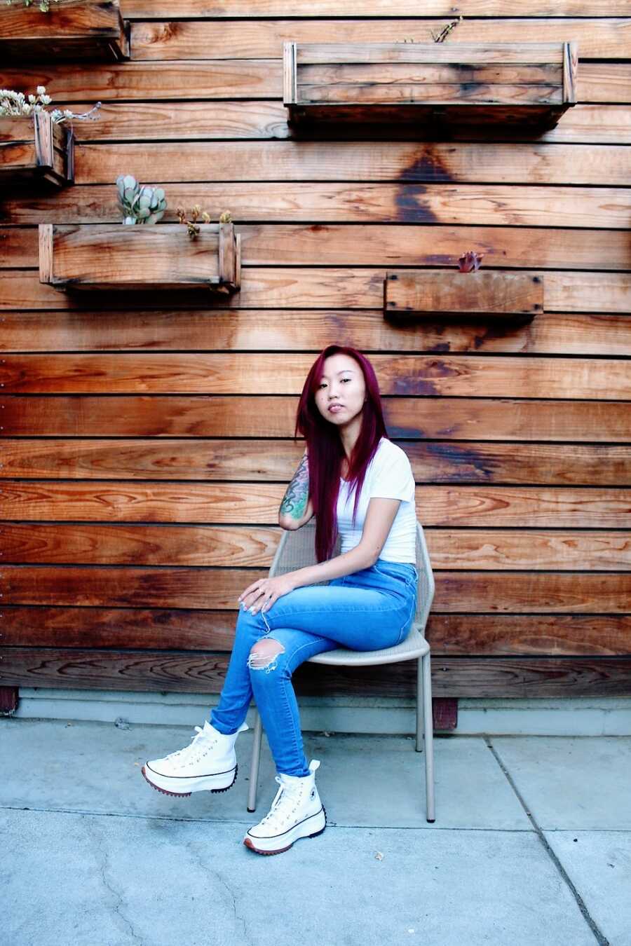 Young woman with cerebral palsy seated in chair