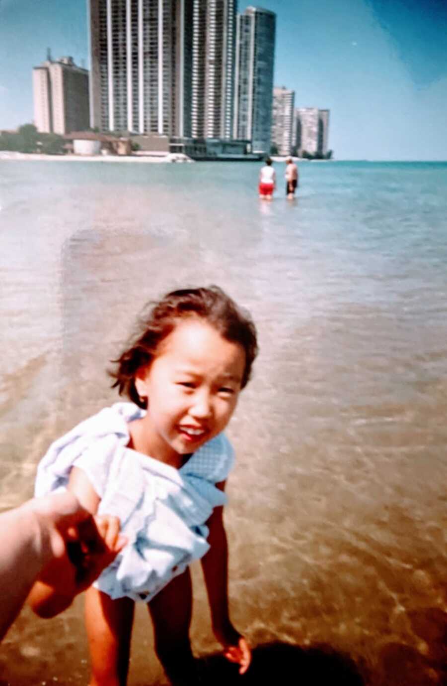 Little girl playing at the beach