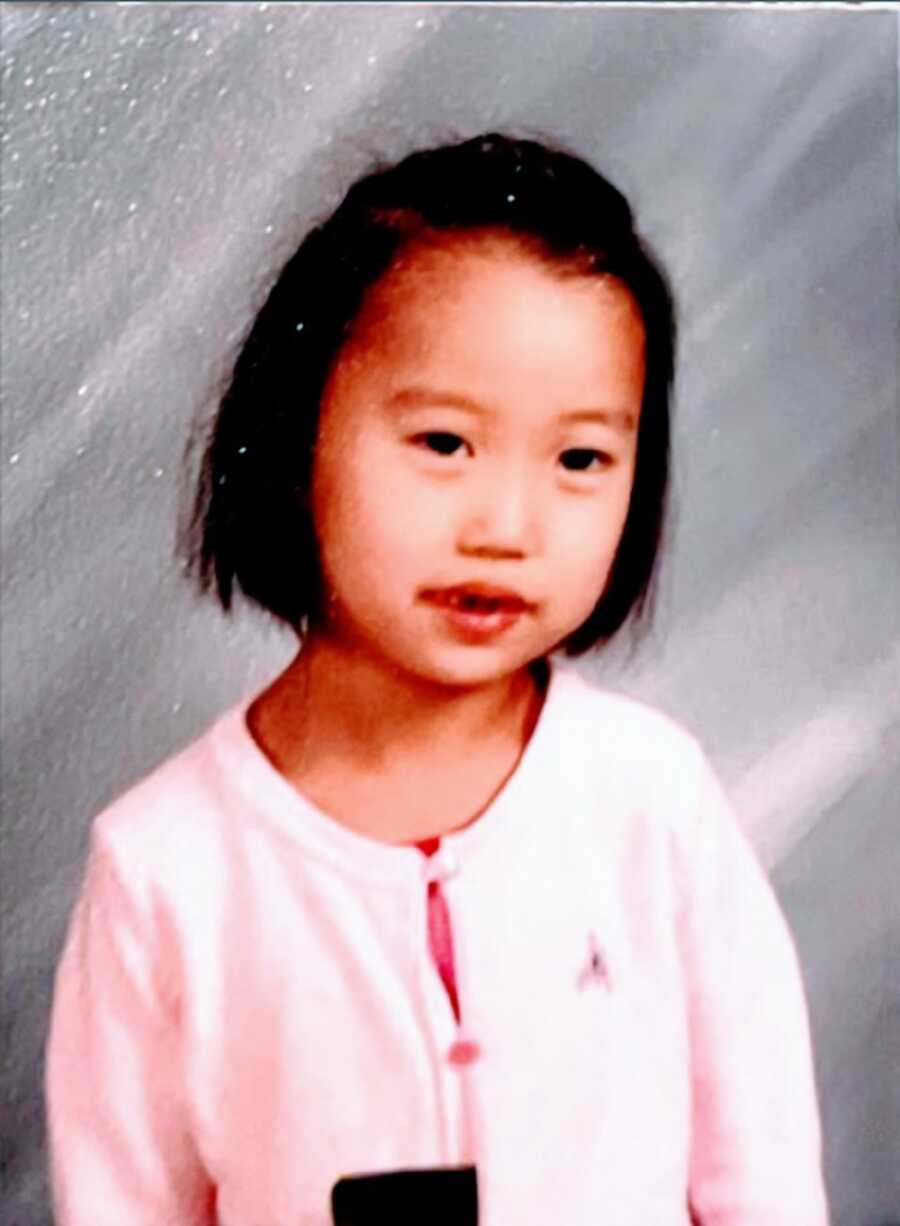 Little girl with cerebral palsy in pink shirt