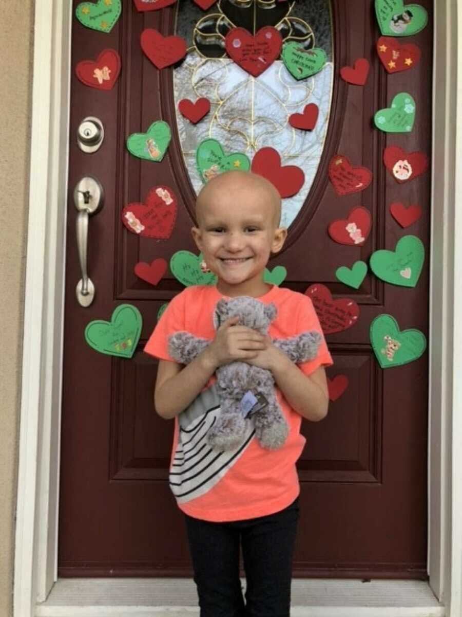 Girl with leukemia holding teddy bear