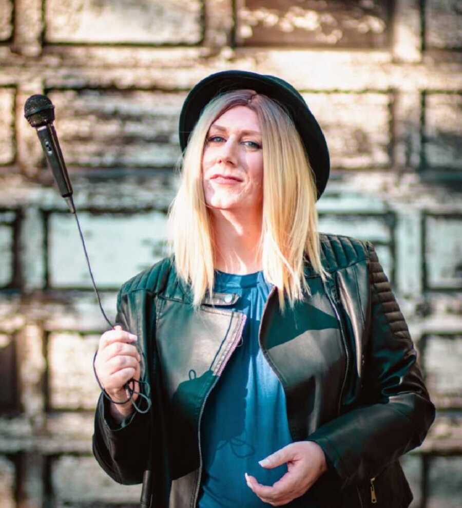 woman with a mic, happy and proud