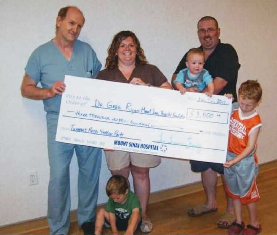 Family donates check to doctor and hospital