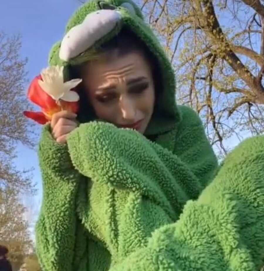 Woman sits at the park, crying and clutching the flowers a couple of little girls gave her.