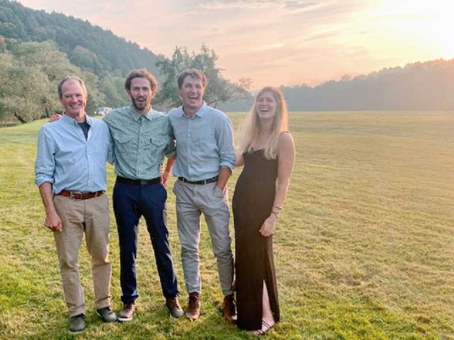 Woman with her brothers and father in a bright field