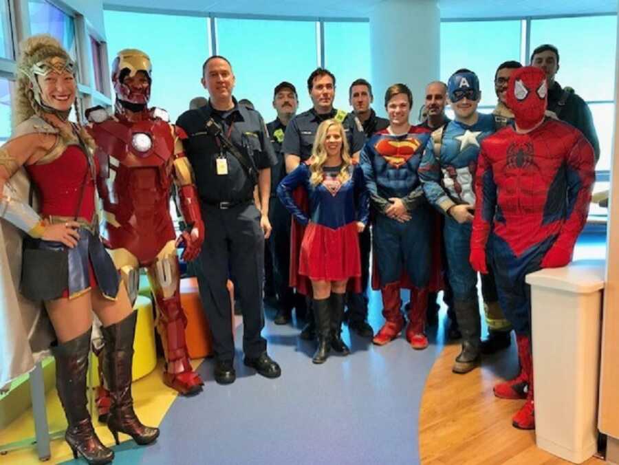 Firefighters dress up in superhero costumes to visit patients in local children's hospital. 