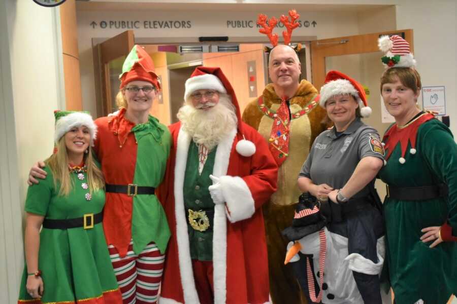 Firefighters dress up in Christmas costumes to visit patients in local children's hospital. 