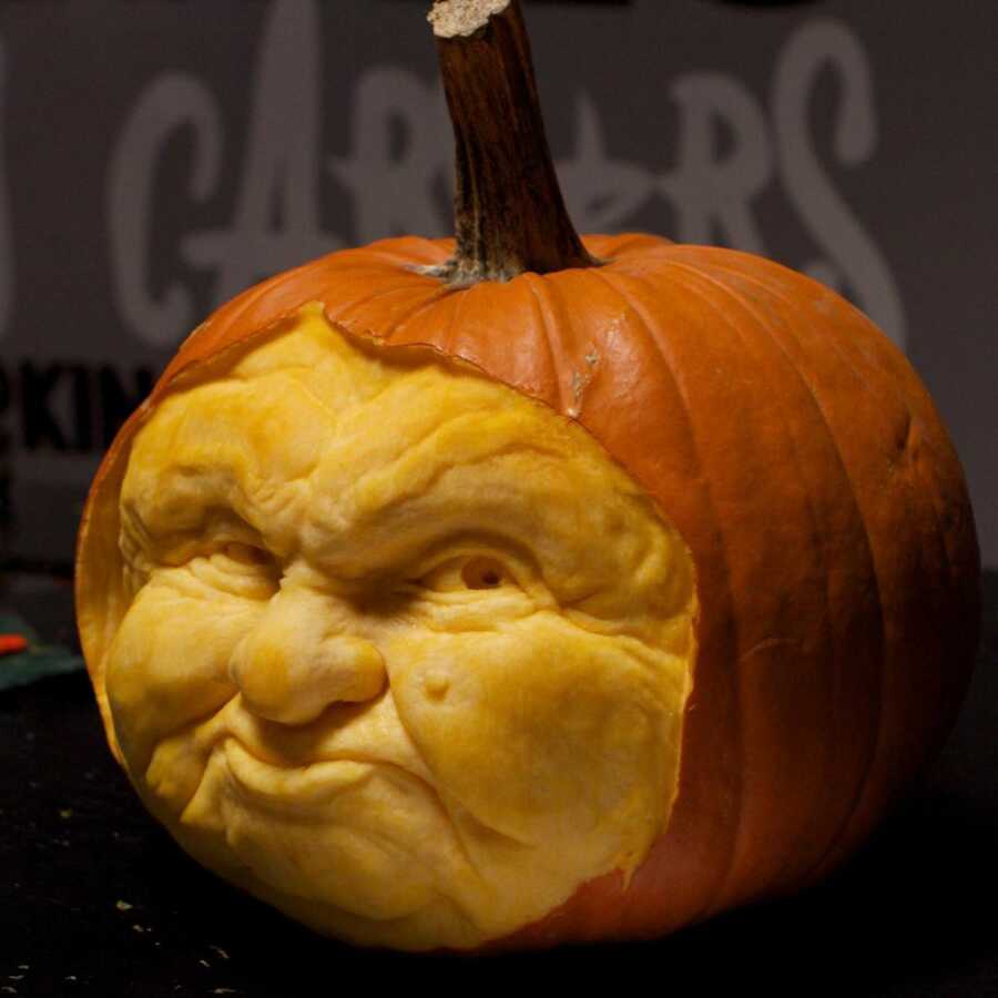 Expressive pumpkin sculpture face, created by Maniac Pumpkin Carvers. 