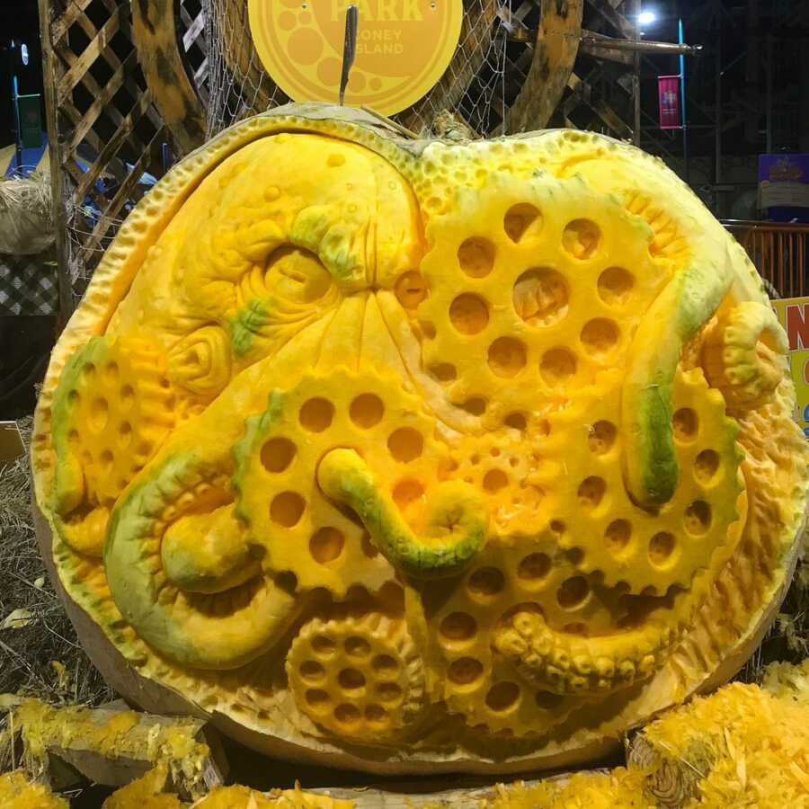 Incredible giant pumpkin sculpture of an octopus, created by Maniac Pumpkin Carvers.