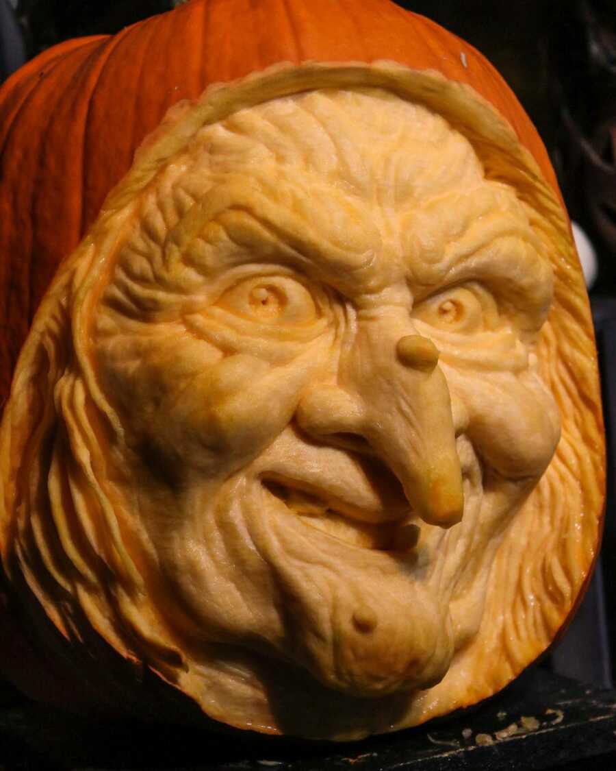 Pumpkin sculpture of a witch's face, created by Maniac Pumpkin Carvers. 