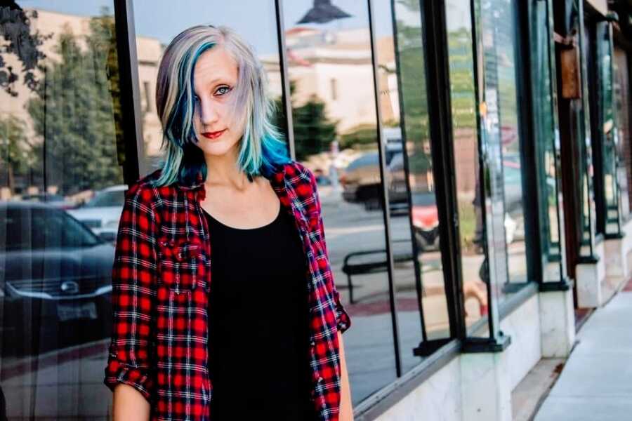 Woman in recovery from anorexia wearing plaid shirt
