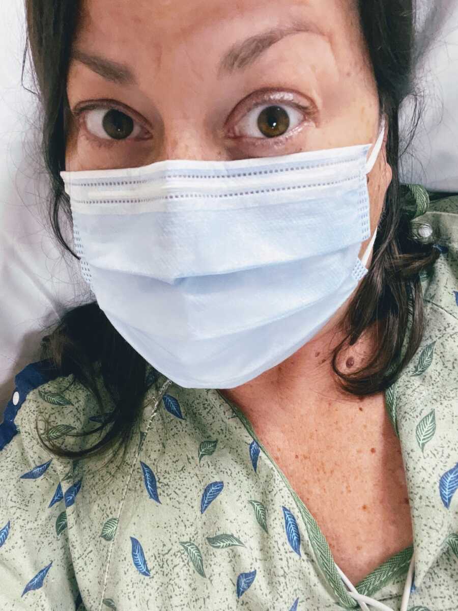 woman wearing mask in ER bed