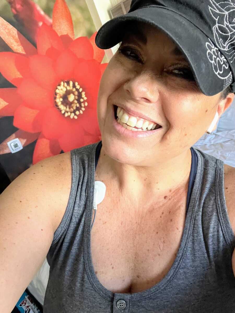 woman wearing hat and earphones smiling