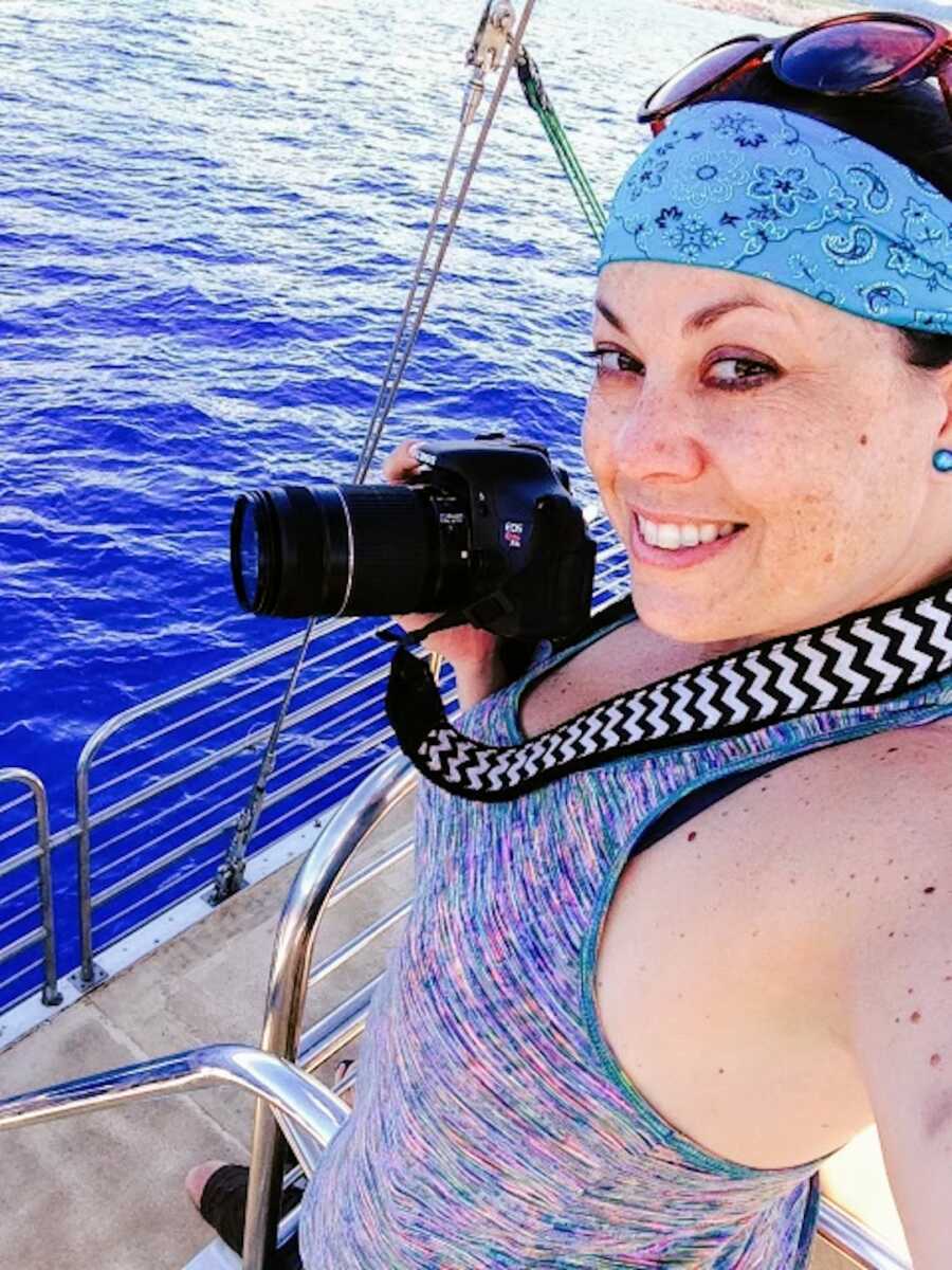 woman on a boat with camera living her life again