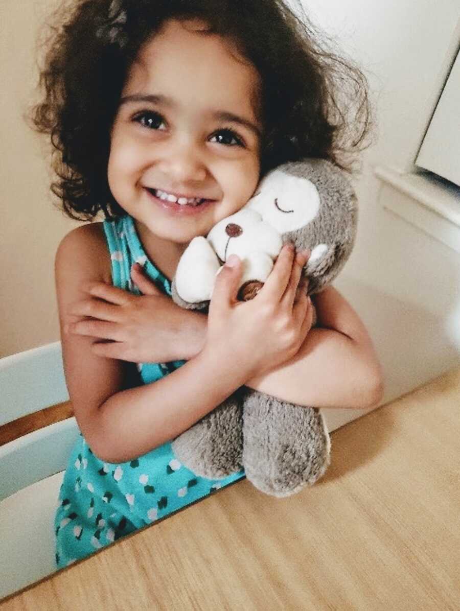 daughter holding her favorite toy she about to give