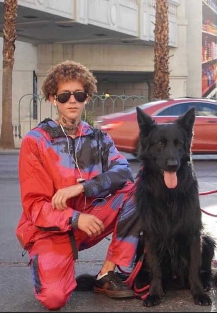 The Dog Daddy poses with his black German Shepherd while out for a walk.