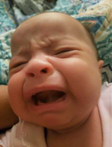 Baby crying because mom burped while feeding them. 