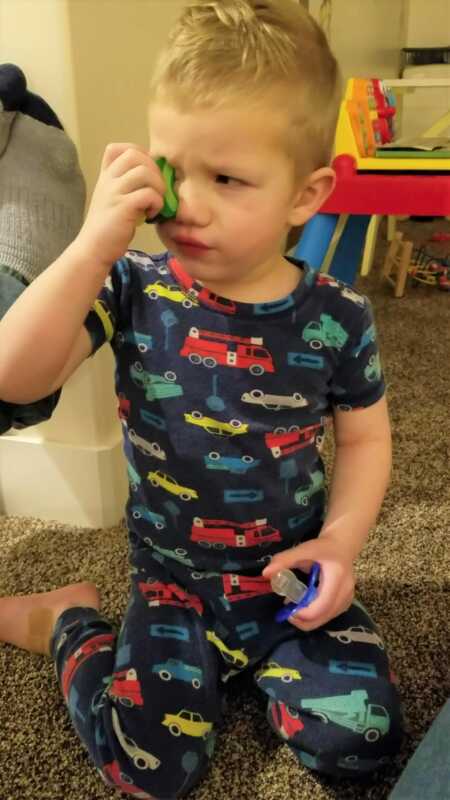 Toddler throwing a tantrum because he couldn't glue toy food to his eyes. 