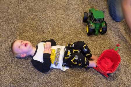 Toddler throwing a tantrum because Santa brought the wrong tractor. 