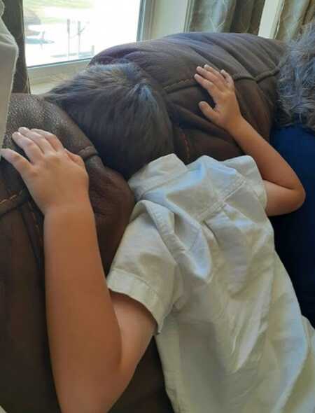 Young boy throwing a tantrum because he'd had enough of family scripture study.