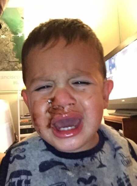 Toddler throwing a tantrum because he couldn't lick the chocolate off his face. 