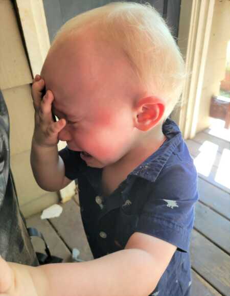 Toddler throwing a tantrum because he can't have coffee. 