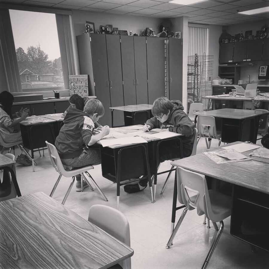 kids sitting at desks working on their school activities 