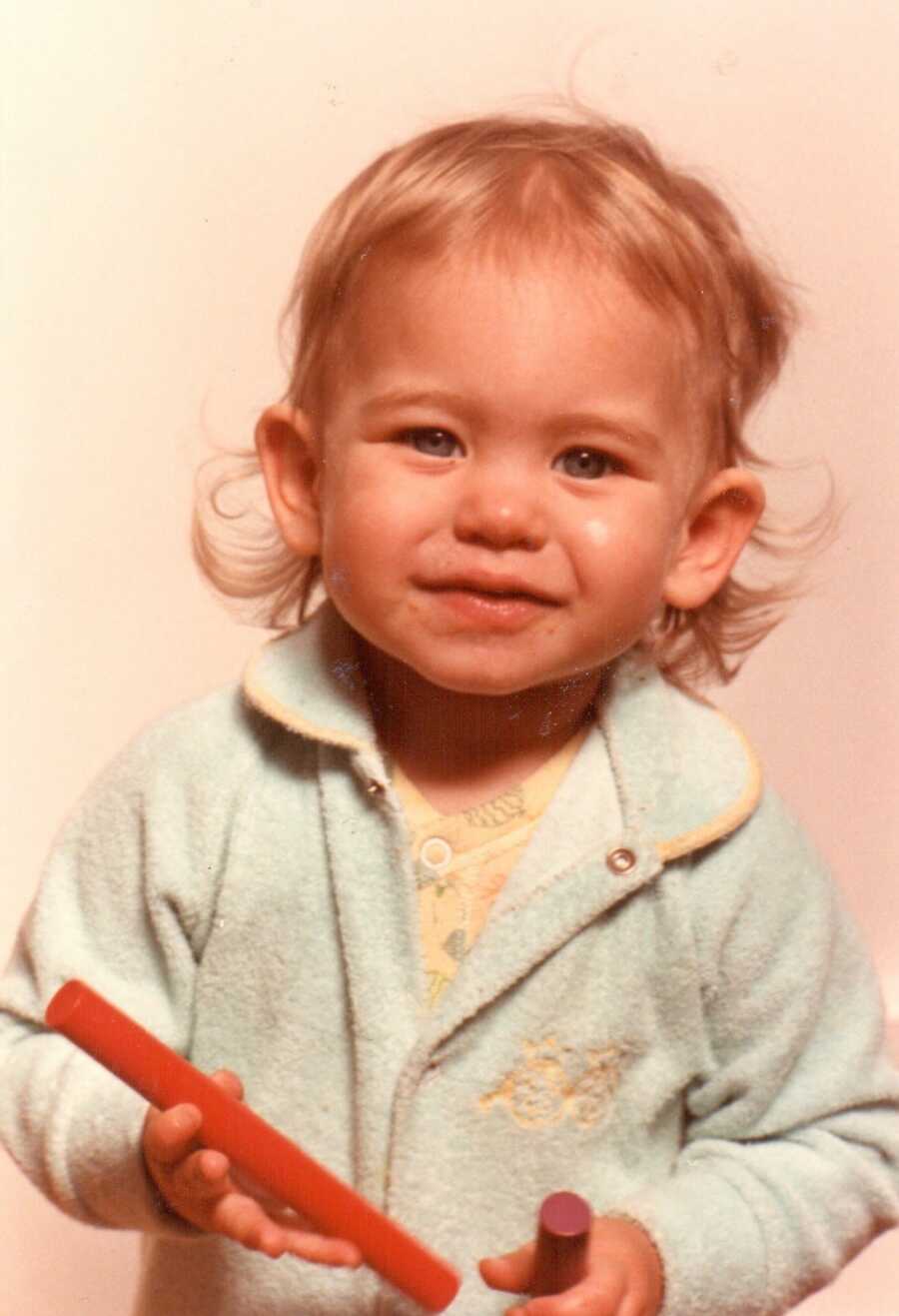 baby girl posing for a pic in the 80s