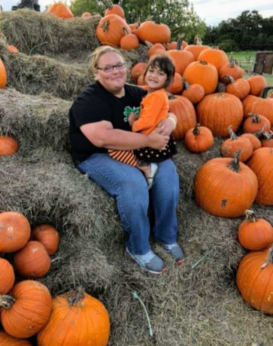 Woman and daughter at pumpkin patch