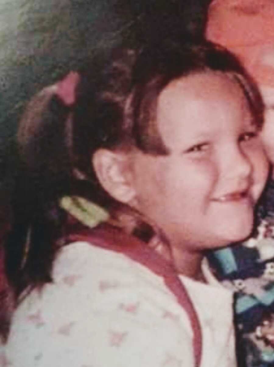 Child survivor of abuse wearing bangs and pigtails