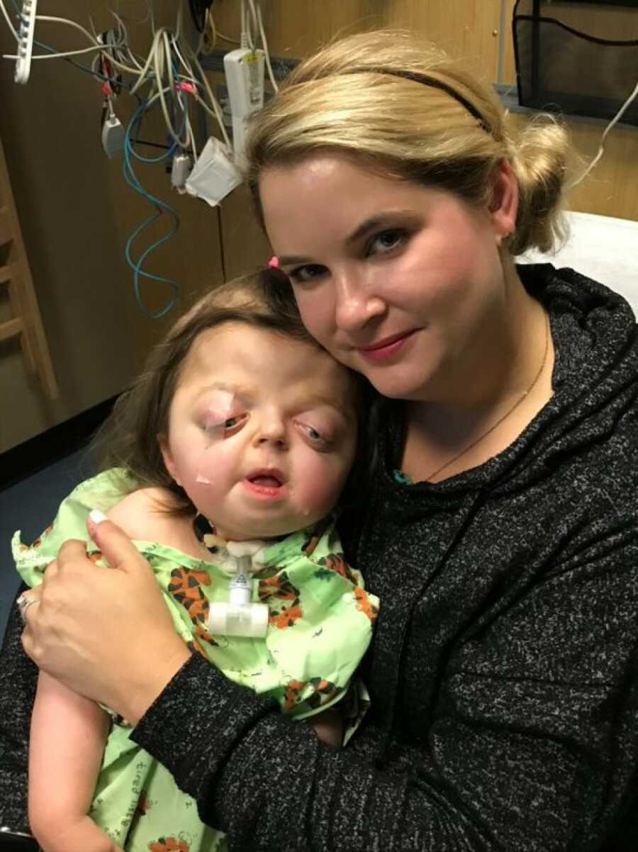 mom holding her daughter after being in the hospital