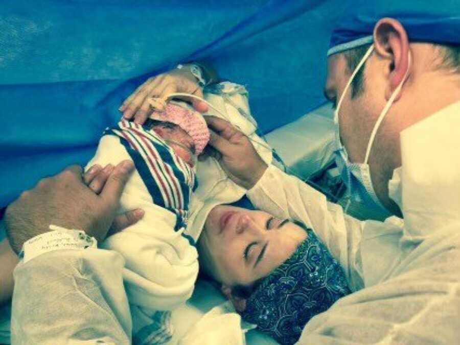 wife and husband with their new born daughter
